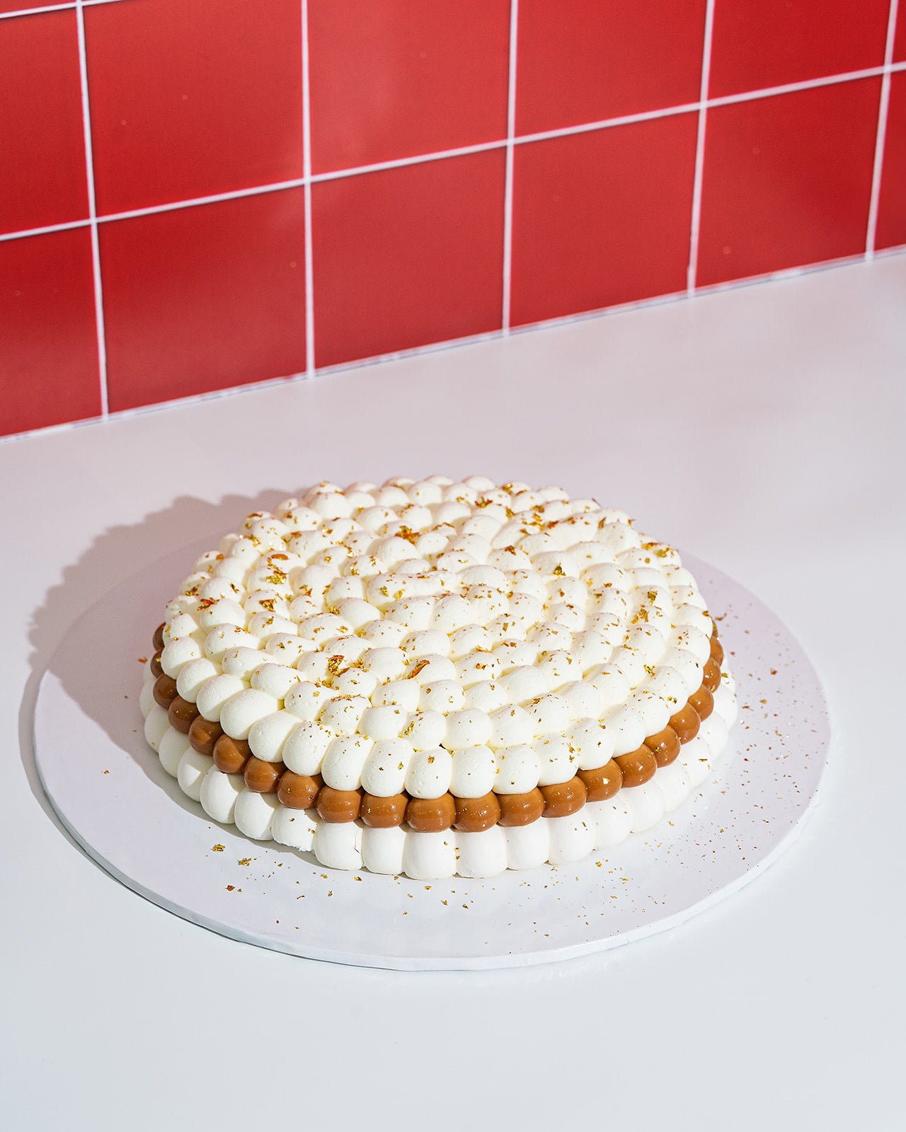 Banana Pavlova gluten free with crisp meringue, dulce de leche, whipped cream and banana slices, topped with golden flakes, made fresh in Miami