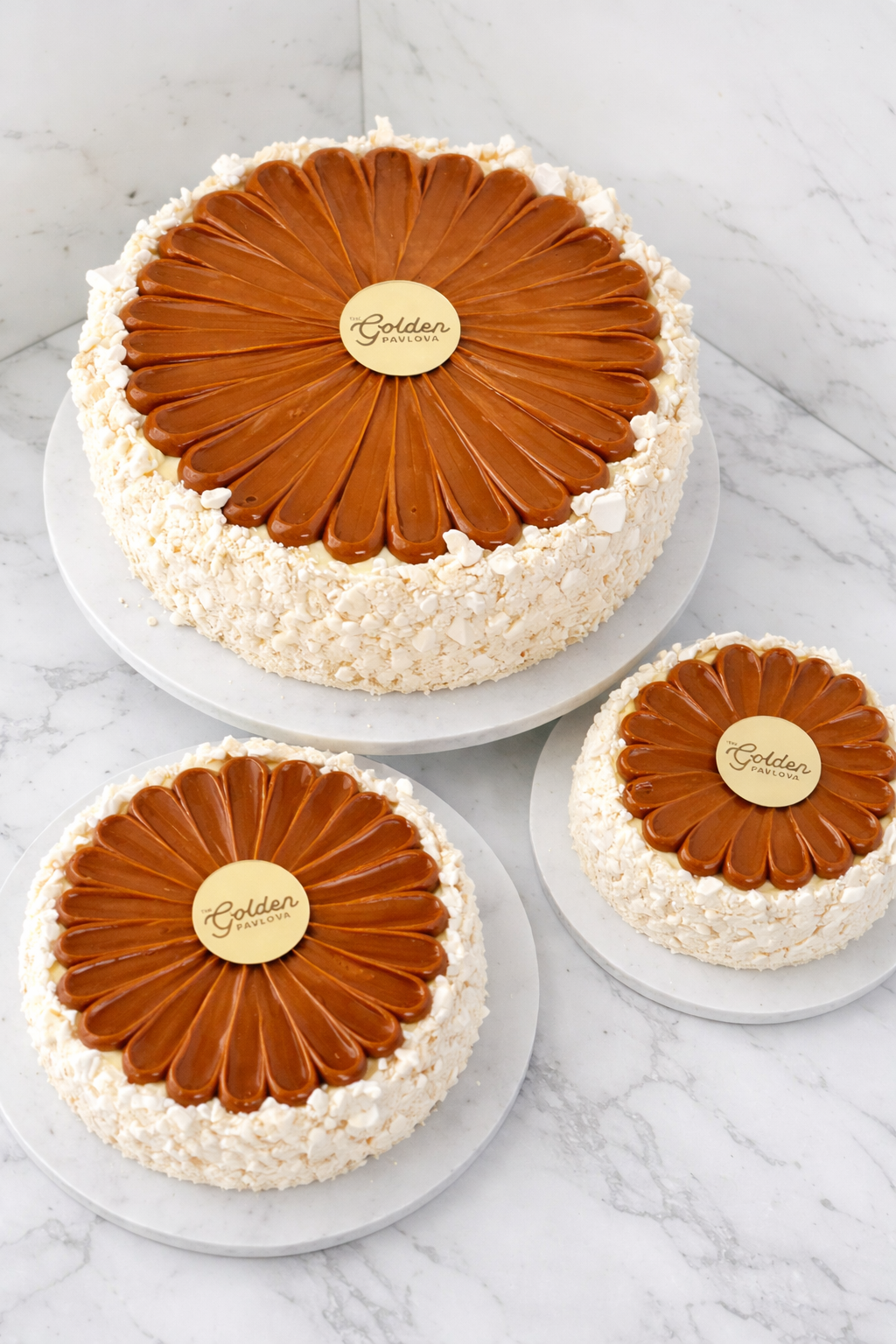 Gluten free artisanal ice cream pavlova cake with crunchy meringue and dulce de leche on a white granite background